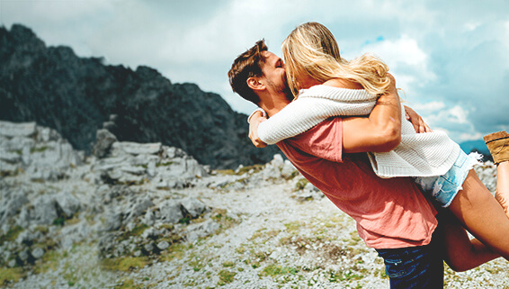 Couple celebrating love on a mountain top